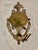 A timeworn antique French Rococo Revival or Colonial Federal Revival door knocker dating to the early 20th century,...