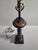 Mid-century metal lamp with a bulbous fluted column that draws from architectural designs from late 18th century early...