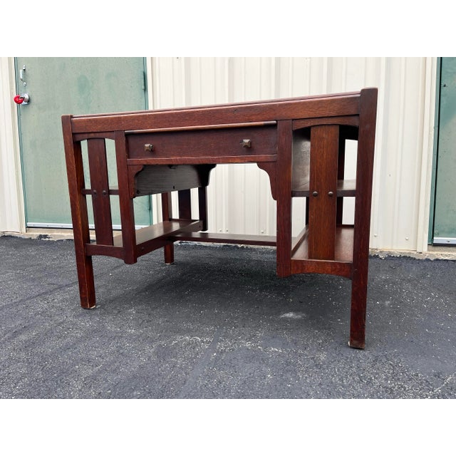 Made by Limberts Furniture, this Mission or Arts and Crafts Oak writing desk is a testament to American craftsmanship and...