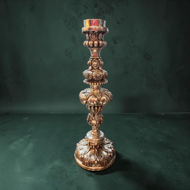 Bring sculptural elegance to your home with this impressive handcrafted D’Argenta silver-plated candlestick. Standing 14.5...