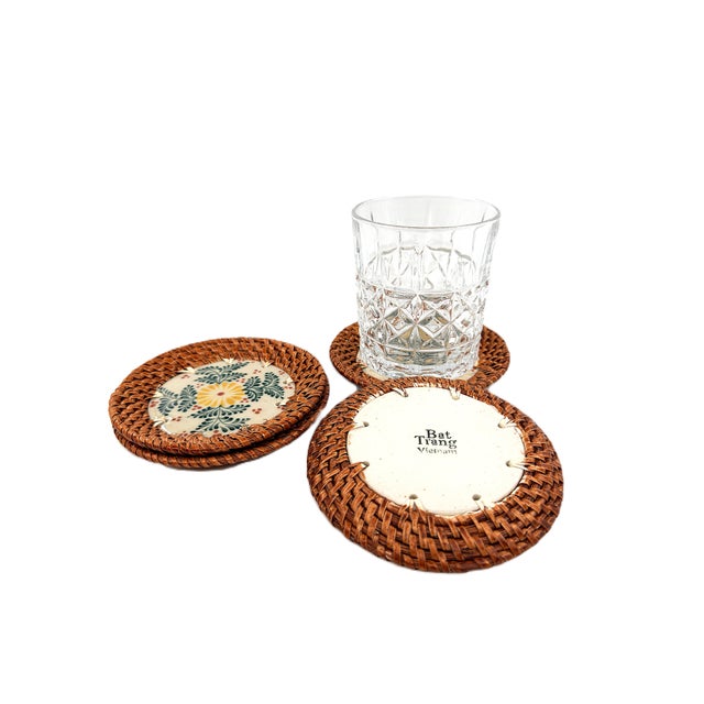 A charming set of four handcrafted coasters from Bat Trang, Vietnam, combining traditional Vietnamese ceramic artistry...