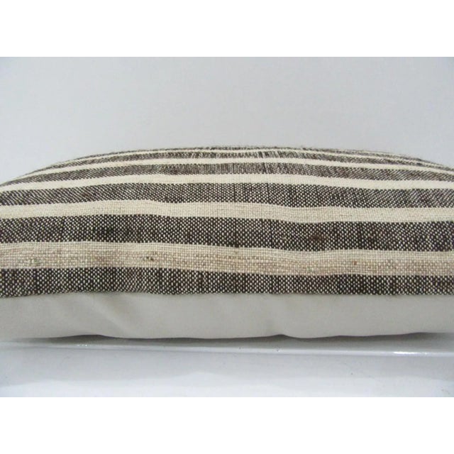 This is a pillow cover made from a vintage kilim rug. The piece was properly washed and ready to use. Pillow inserts not...