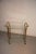 This bar cart originates from the 1970s and is made from gold brass with cut glass trays.