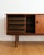 Danish teak sideboard from the 1950s, 200 cm. Two large sliding doors with recessed vertical handles sit on tapered legs....