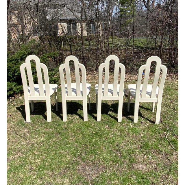 Set of four 1980’s sculptural mod cream lacquered Italian dining chairs made by SPA Tonon. New fabric recommended. Please...