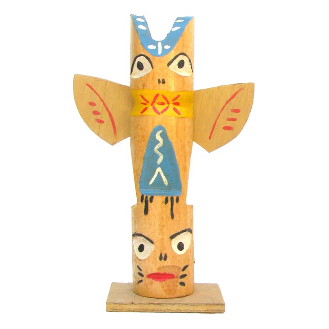 Pair of whimsical and colorful artisan-made painted wood totem pole sculptures believed to be from the 1960s. Vintage...