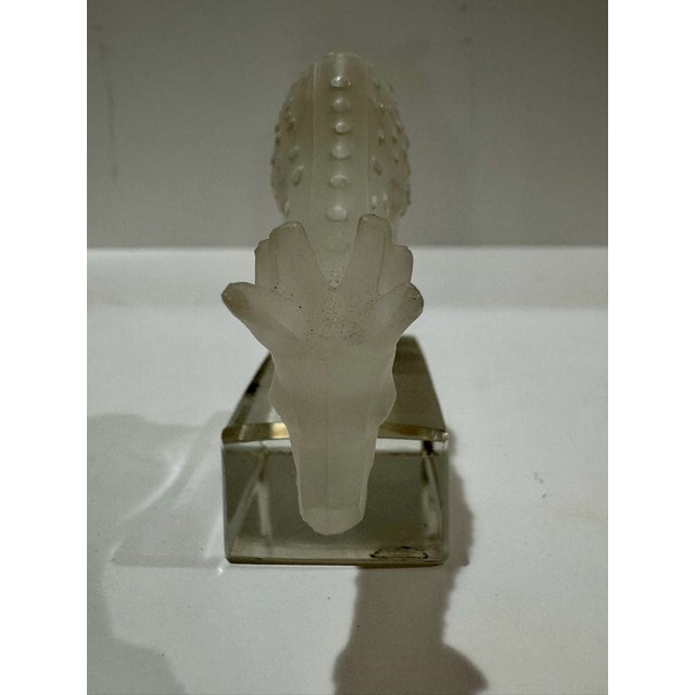 Lalique Francec rystal figurine depicting a spotted deer or fawn grazing with its head lowered. The animal is rendered in...