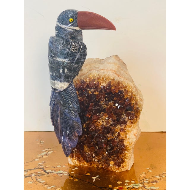 Gorgeous semiprecious stones carved toucan bird on an impressive intense color citrine geode specimen.