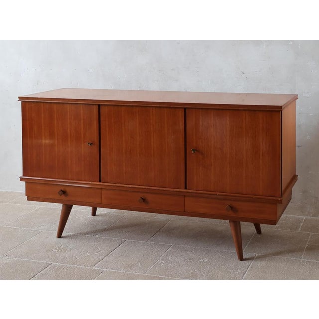 This sideboard is a rare 1960s design by French designer Gaston Poisson. Crafted in teak, it bears the master's signature:...