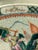 A striking antique Chinese porcelain charger decorated in the famille verte palette with an animated battle scene...
