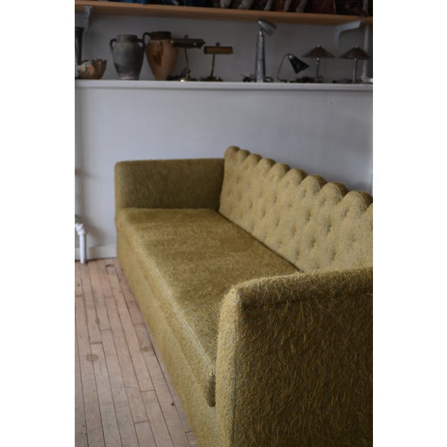 A luxurious custom scalloped tuxedo sofa in olive green. Seat back is diamond tufted with a scalloped crest rail. New...