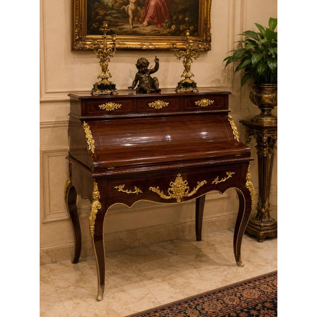 A breathtaking example of French craftsmanship, this Louis XV Secretary Desk is handcrafted from solid mahogany and...