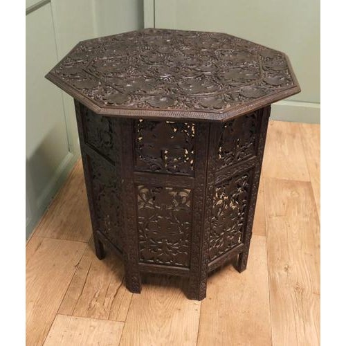 This is a beautiful piece carved all over the top and the base with vines and grapes, the table top has 8 sides and sits...