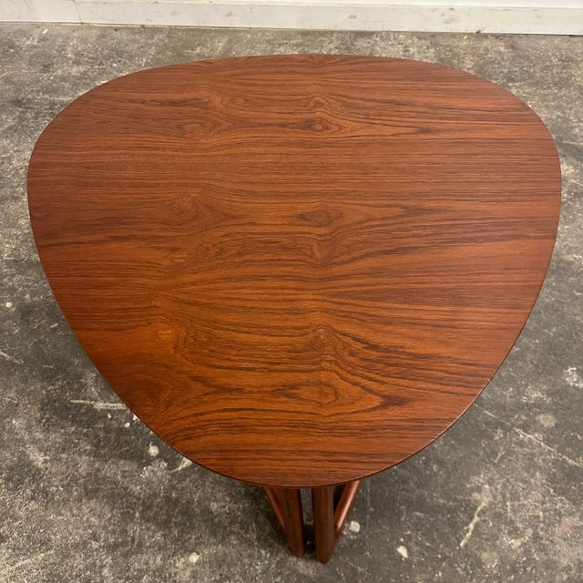 This 1950s foldable side table was designed by Danish designers Peter Hvidt and Oral Mølgaard-Nielsen for France &...