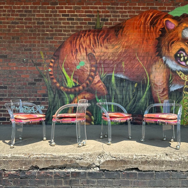 This stunning dining set by Charles Hollis Jones includes a round glass-top table with Lucite legs and four Lucite chairs...