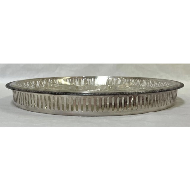 Perfect for entertaining! This silver plate serving tray has a reticulated edge detail with scrolled designs on the...