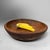 A beautiful Japanese wooden dough bowl, hand-carved from solid wood, with a warm natural tone, deep rounded form and...
