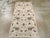 This mid-20th century Turkish Anatolian rug, measuring 2' 11" x 5' 11", features a delicate allover pattern composed of...