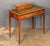 A fine English writing table or desk of mahogany from the Edwardian era, featuring an inset leather top embossed with gilt...