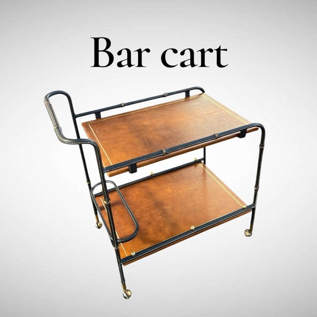 A Rare French Midcentury Modern hand stitched leather bar cart by Jacques Adnet, circa 1955. Adnet had a rare talent for...