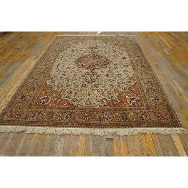 "This is a sophisticated, mid-sized antique Tabriz rug, dating back to circa 1940. Measuring 6' x 9'1", this formal carpet...