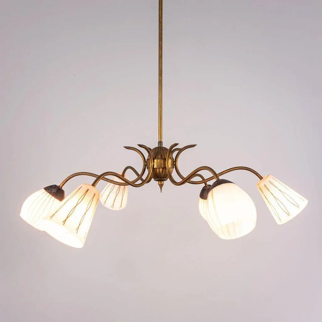 Chandelier with 6 lights. Brass structure. Opal glass diffusers in spherical and conical shape. Good condition, with signs...