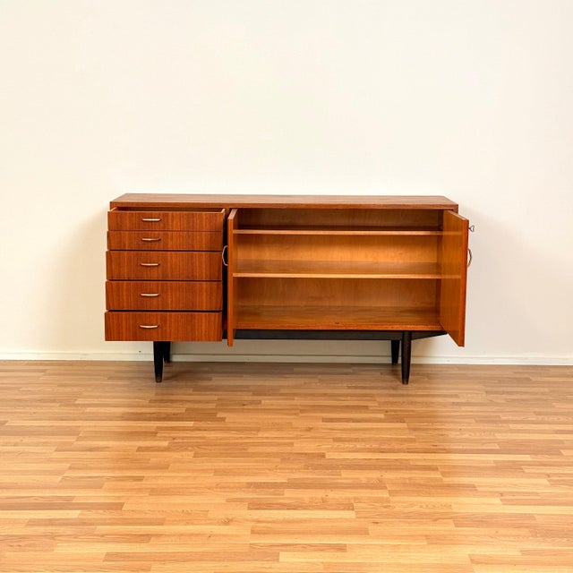 Sideboard manufactured in Sweden in the 1950s-60s. It is made of teak veneer on the structure and solid stained wood on...