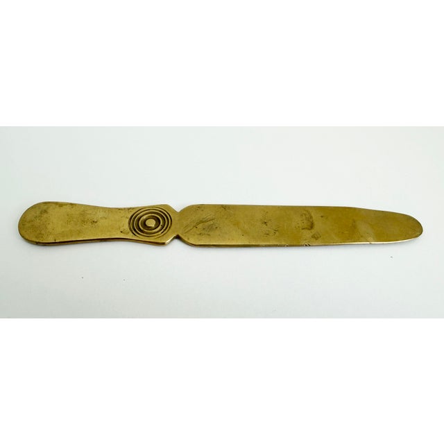 Antique solid brass letter opener with embossed circular detail on the handle. Nice weight in hand. Circa late 1800s to...