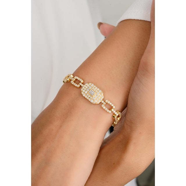 This designer diamond cluster bracelet showcases a breathtaking array of carefully arranged diamonds, creating a stunning,...