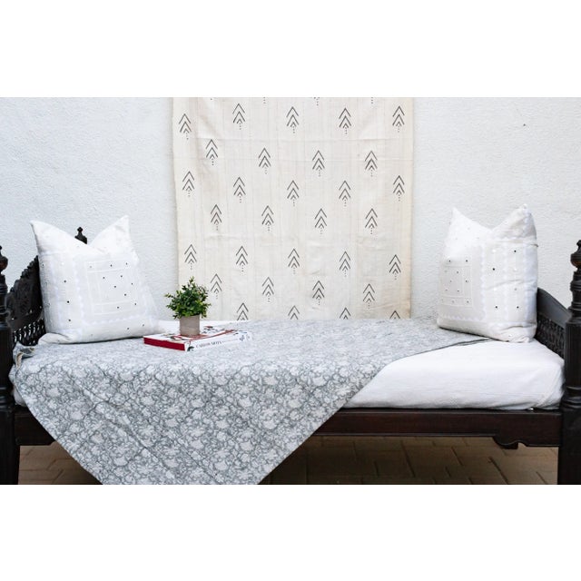 Inspired by traditional Indian kantha quilts, this cotton coverlet features a block-style print of tribal designs and...