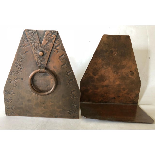 Lovely arts and crafts pair of copper bookends fit flat up against the books requiring no extra room on your bookshelf....
