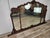 An elegant period Italian mirror, featuring a richly carved and shaped wooden frame with refined ornamental motifs of...