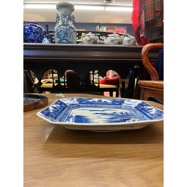 square plate with cut angled corners blue and white pastoral landscape scene Arita Imari blue is iconic Japanese porcelain...