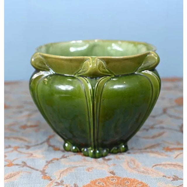An elegant art nouveau porcelain with green finish Offered in great shape ready for home use right away Circa 1910 Rounded...