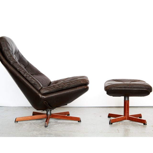 Lounge chair in classic mid-century style from Denmark by Madsen & Schübell. Fully upholstered in dark brown leather....