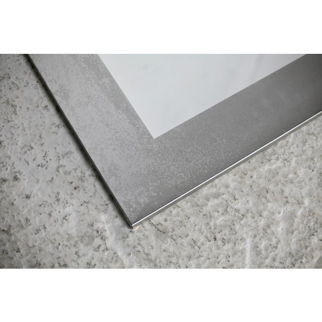 Large steel mirror from the 70s. Small marks on the stainless steel. see photos. clean shape Hangs in both directions....