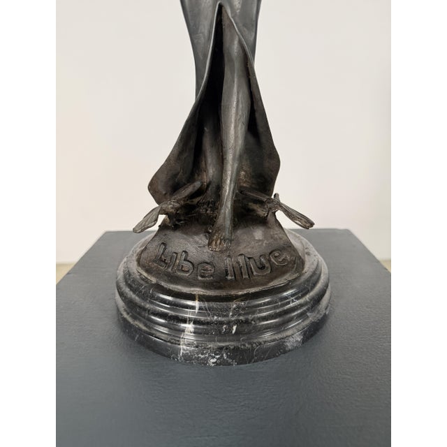 Art Nouveau-style bronze sculpture depicting a female figure with dramatic dragonfly-like wings, titled Libellule—the...