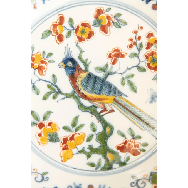 A gorgeous vintage Dutch Delft faience polychrome floral wall charger plate by Royal Tichelaar Makkum, circa 1940. Maker's...