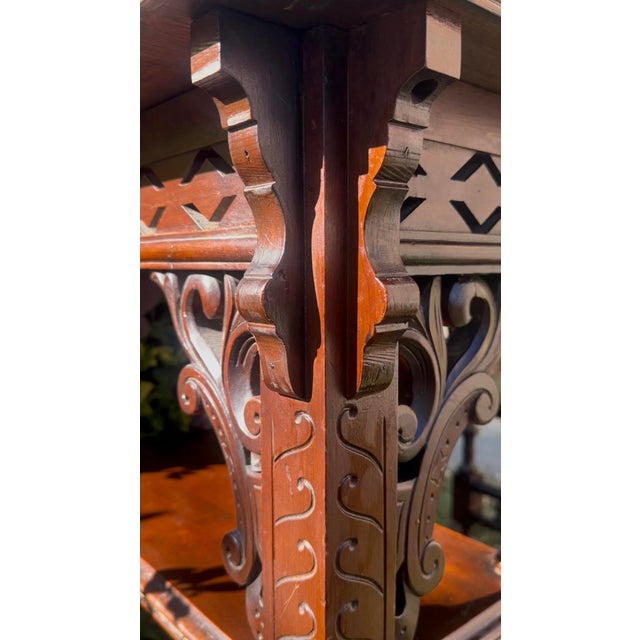 An exceptionally decorative antique Victorian mahogany writing table featuring elaborate pierced fretwork, intricate...