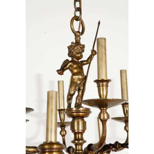 Beautiful cast antique brass fixture with cherub detail; newly wired for 12 candelabra bulbs up to 60 watts each.