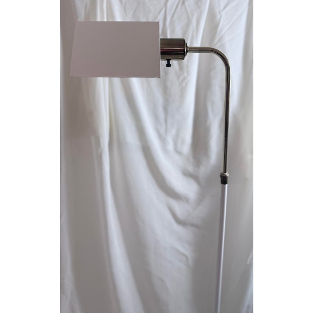 A refined contemporary floor lamp with architectural lines and a sleek brushed nickel finish. This adjustable pharmacy-...