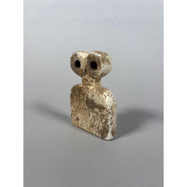 Bell-shaped "eye" idol. Tell Brak, Middle East. It has a bell-shaped body surmounted by two pierced eyes. Sculpture in...