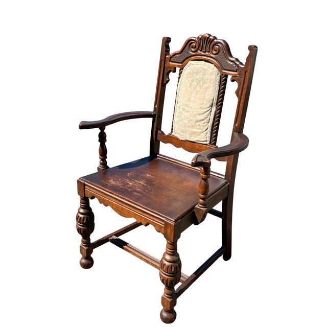 A handsome set of six early 20th-century Jacobean Revival dining chairs crafted in richly toned oak and featuring...