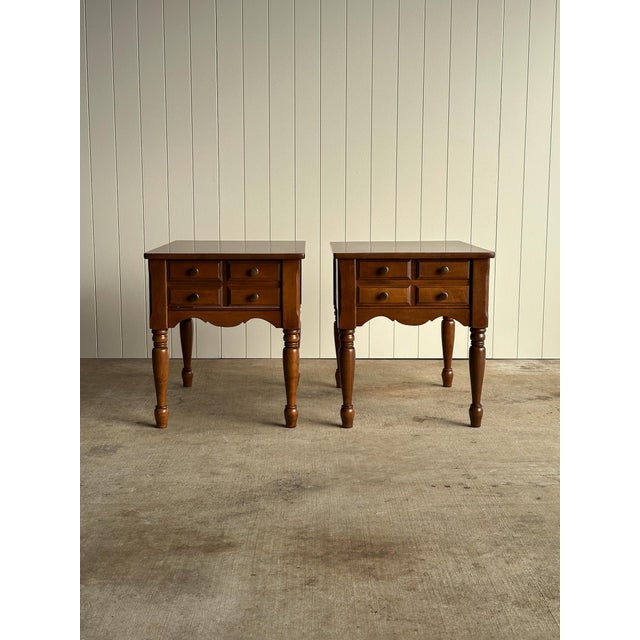 Pair of vintage mid century side tables crafted with solid maple wood frames and durable wood-grain laminate tops. Each...