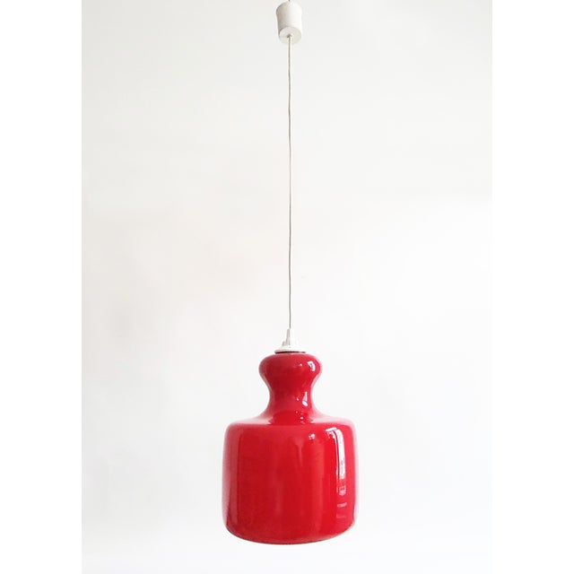 Beautiful dark cherry red Space Age glass pendant lamp in a minimalist, opulent and fluidly organic shape typical for...