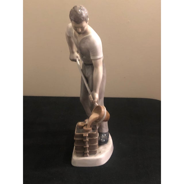An impressive and substantial mid-century Danish porcelain sculpture titled "Ironfounder" (Smelter), model #2335, created...