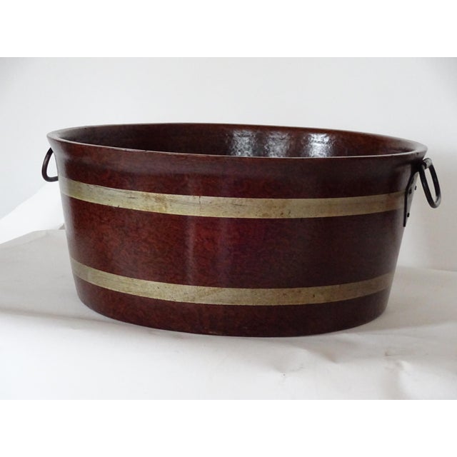 English grained -painted wood papier-mache tub with painted gold bands. Wrought- iron drop handles and an impressed...