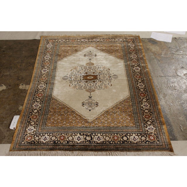 Originating from Persia circa 1950-1960, this vintage Persian rug is a distinct piece of its Qum design lineage with...