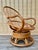 Vintage Bohemian Style Bent Rattan Swivel Lounge Chair in the Paul Frankl's Manner. Circa 1970s Features a natural finish...