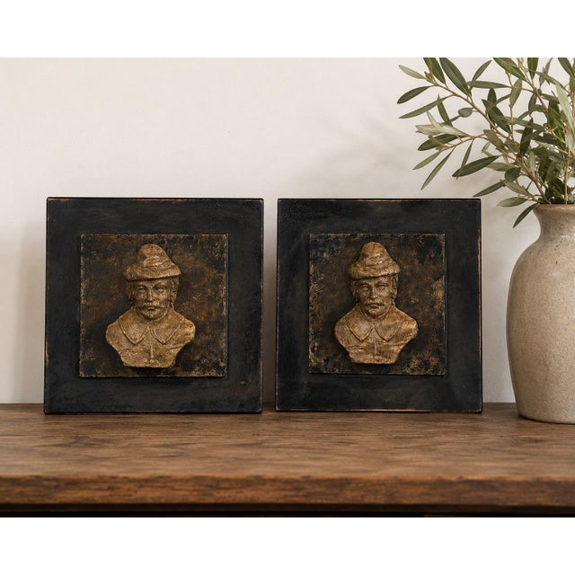 A striking pair of vintage French Breton-style relief wall plaques featuring sculptural bust portraits rendered in a...
